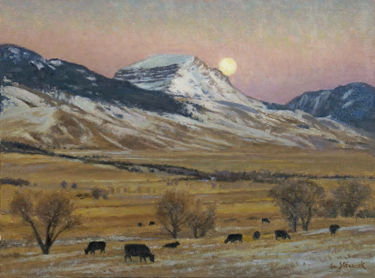 November Moonrise – Sphinx Mountain by Lee Stroncek captures cattle grazing in a golden valley beneath a snow-dusted mountain at moonrise.
